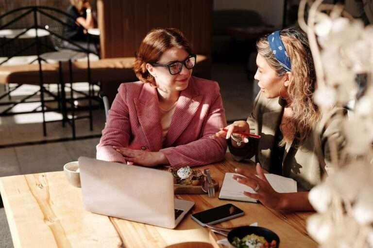 NDIS Woman in Red Blazer Sitting by the Table Having a Meeting